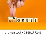 Small photo of Regress or progress symbol. Businessman turns wooden cubes and changes the word 'regress' to 'progress'. Beautiful orange table, orange background, copy space. Business, regress or progress concept.