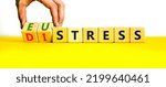 Small photo of Eustress or distress symbol. Psychologist turns cubes and changes the concept word Eustress to Distress. Beautiful yellow table white background, copy space. Psychlogical distress or eustress concept.
