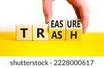 Small photo of Trash to treasure symbol. Businessman turns cubes and changes the word trash to treasure. Beautiful yellow table, white background. Business, trash to treasure concept. Copy space.