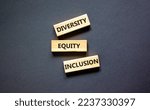 Small photo of Diversity equity inclusion symbol. Concept words diversity equity inclusion on blocks on beautiful black table black background. Business, diversity equity inclusion concept.