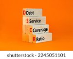 Small photo of DSCR debt service coverage ratio symbol. Concept words DSCR debt service coverage ratio on wooden block on beautiful orange background. Business DSCR debt service coverage ratio concept. Copy space.