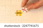 Small photo of Crypto downfall symbol. Concept words Cryptos downfall on white paper puzzles. Beautiful yellow table white background. Businessman hand. Business and crypto downfall concept. Copy space.