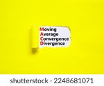 Small photo of MACD symbol. Concept words MACD moving average convergence divergence on white paper on beautiful yellow background. Business MACD moving average convergence divergence concept. Copy space.