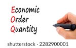 Small photo of EOQ economic order quantity symbol. Concept words EOQ economic order quantity on paper on a beautiful white background. Businessman hand. Business EOQ economic order quantity concept. Copy space.