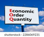 Small photo of EOQ economic order quantity symbol. Concept words EOQ economic order quantity on big white billboard against beautiful blue sky background. Business EOQ economic order quantity concept. Copy space.