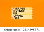 Small photo of ARPPU average revenue per paying user symbol. Concept words ARPPU average revenue per paying user on wood stick. Beautiful orange background. Business ARPPU average revenue per paying user concept.