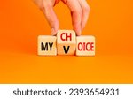 Small photo of My voice choice symbol. Businessman turns wooden cubes and changes the concept word My choice to My voice. Beautiful orange table orange background, copy space. Business and my voice choice concept