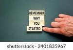 Small photo of Remember why you started symbol. Concept word Remember why you started on wooden block. Beautiful grey table grey background. Businessman hand. Business remember why you started concept. Copy space.