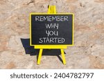 Small photo of Remember why you started symbol. Concept word Remember why you started on beautiful black chalk blackboard. Beautiful red stone background. Business remember why you started concept. Copy space.