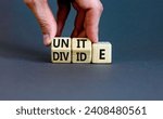 Small photo of Unite or divide symbol. Concept word Unite or Divide on wooden cubes. Beautiful grey table grey background. Businessman hand. Business unite or divide concept. Copy space.