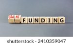 Small photo of Grant funding symbol. Concept words Grant funding on beautiful wooden blocks. Beautiful grey table grey background. Business and grant funding concept. Copy space.