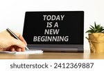 Small photo of Today is a new beginning symbol. Concept words Today is a new beginning on beautiful black tablet. Businessman hand. Beautiful white background. Business today is new beginning concept. Copy space.