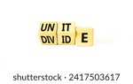 Small photo of Unite or divide symbol. Concept word Unite or Divide on wooden cubes. Beautiful white table white background. Business unite or divide concept. Copy space.