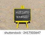 Motivate yourself symbol. Concept words Motivate yourself on beautiful black chalk blackboard. Chalkboard. Beautiful sand background. Business psychology motivate yourself concept. Copy space.