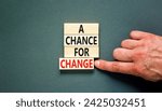 Small photo of A chance for change symbol. Concept words A chance for change on beautiful wooden block. Beautiful grey table grey background. Voter hand. Business A chance for change concept. Copy space.