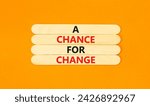 Small photo of A chance for change symbol. Concept words A chance for change on wooden stick. Beautiful orange table orange background. Business A chance for change concept. Copy space.