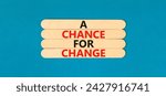 Small photo of A chance for change symbol. Concept words A chance for change on wooden stick. Beautiful blue table blue background. Business A chance for change concept. Copy space.