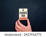 Small photo of A chance for change symbol. Concept words A chance for change on beautiful wooden block. Beautiful black table black background. Voter hand. Business A chance for change concept. Copy space.