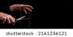 Small photo of Banner with man cutting strings on hands with scissors. Abuse, violence, slavery cessation. Overcoming addiction and mental health problems. Getting rid of manipulation. Copy space. High quality photo