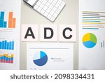 Small photo of adc business, search engine optimazion,Text on the sheets of paper, charts and white calculator