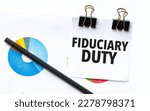 Small photo of fiduciary duty on notebook with charts and pencil