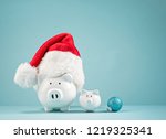 Piggy bank wearing santa hat - Saving money for Christmas Concept
