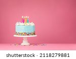 Blue Birthday Cake with Five Candles over Pink Background