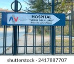 Small photo of Alcoy, Alicante, Spain - December 11th 2023. Direction sign to Hospital Virgen de los Lirios. Hospital Verge dels Lliris. Illustrative editorial signpost
