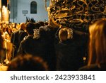 Small photo of April 8th 2023 - Dona Mencia, Cordoba, Spain. Costaleros carry the Virgin of Solitude on shoulder in altar on wooden poles. Bearer carrying Paso de Semana Santa