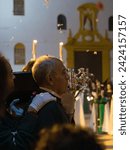 Small photo of April 8th 2023 - Dona Mencia, Cordoba, Spain. Costalero carry the Virgin of Solitude on shoulder in altar on wooden poles. Bearer carrying Paso de Semana Santa. Portrait close up