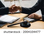 Small photo of Attorney or judge shaking hands to Businessman seal a deal Judges male lawyers Consultation legal services Consulting in regard to the various contracts to plan the case in court.