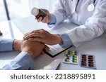 Small photo of Friendly male doctor hands holding patient hand sitting at the desk for encouragement, empathy, cheering, and support while medical examination. Bad news lessening, medicine, and health care concept