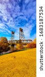 Small photo of Portrait shot of a bridge overtop a lake canal in Lathrop California