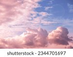 Beautiful fabulous pink cumulus clouds in the blue sky at sunset. natural background