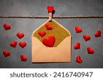 clothespin with red heart on a rope on a gray background. an envelope with a red heart inside. symbol of love, passion. flat lay, top view, Love, Valentine's Day February 14, Wedding