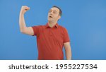 Small photo of Male mocks the interlocutor showing a hand blah blah blah gesture.Movements and body language concept.Indoor studio shot isolated on blue background