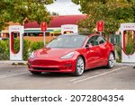 Small photo of Fremont, CA, USA - October 30, 2021: Red Tesla at the charging station.