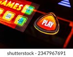 Small photo of Play button on a slot machine.