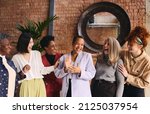 Small photo of International Women's Day portrait of cheerful multiethnic mixed age range businesswomen celebrating, Embrace Equity