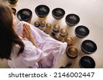 Small photo of Close-up of a Tibetan singing bowl in your hands - Translation of mantras: transform your impure body, speech and mind into a pure exalted body, speech and mind of a Buddha.