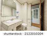 Small photo of Toilet with vintage kitsch decoration with white toilets and patterned tiles