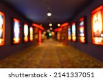 Small photo of Movie theater entrance interior blur image use for background of business and cinema concept. Abstract blurred image of lobby of movie theater in Vietnam.