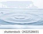 Small photo of An indentation after a drop falls into water on a white background