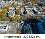 an aerial shot of the office buildings, apartments, city hall, red and yellow autumn trees, lush green trees and grass, Christmas tree and parked cars at Decatur Square in Decatur Georgia USA
