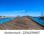 A Long Brown Wooden Pier With...