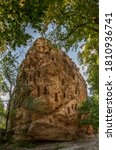 Small photo of Ancient Thracian rock sanctuary "Deaf stones" (Gluhite kamani) in the southern Rhodopes, Bulgaria - A huge rock among the trees Thracian trapezoidal niches