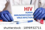 Small photo of HIV card in hands of medical Doctor. Doctor's hands in blue gloves holding a sheet of paper with text HIV - short for HUMAN IMMUNODEFICIENCY VIRUS INFECTION , medical concept.