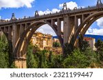 Small photo of San Jorge bridge in Art Deco style over the deep valley of the River Riquer. Houses of the old town on the hillside captured under the arches of the concrete impressive viaduct in Alcoy, Alcoi, Spain
