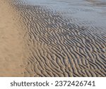 A sand ripple textured background on the shoreline