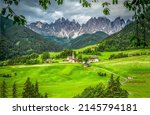 A mountain Alpine village in a green valley. Mountain village in Alps. Alpine village in mountain landscape. Mountain village in Alps landscape